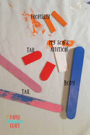 Painted popsicle sticks on various sizes that will be created into a popsicle stick airplane craft.