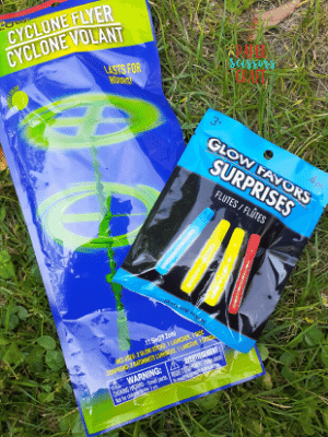 Two glow stick packages laying in the grass.