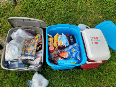 Plastic bins filled with camping supplies.