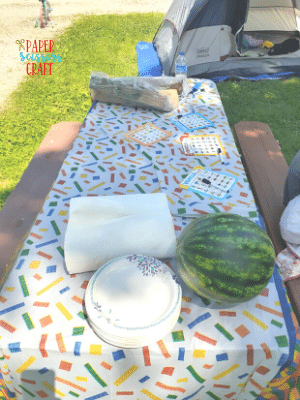 Picnic table with plastic tablecloth.