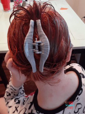 Girls dyed wet hair in an updo using a hair clip.
