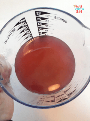 Measuring cup containing the remove Kool-Aid hair dye.