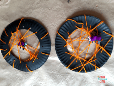Completed paper plate spider web crafts.