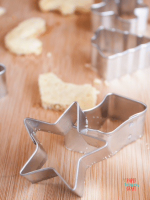 Star and stocking shape cookie cutters on a table.