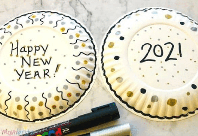 Homemade noisemakers made of paper plates for ringing in the new year.