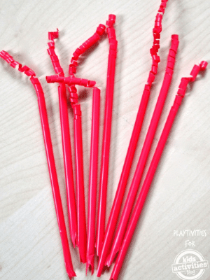 Red straw noise makers on a table.