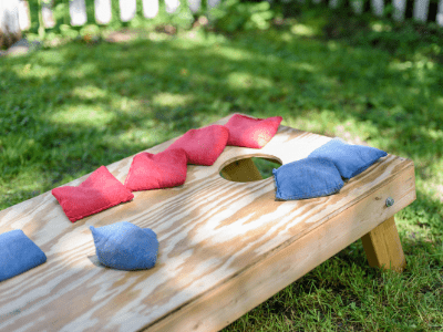 Corn hold board with red and blue bean bags sitting on top.