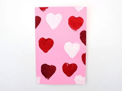 Valentine's Day card with cover that is sponge painted in heart shapes.