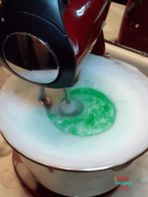 Foaming bubbles with green dye and a kitchen mixer.