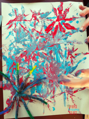 Fireworks pipe cleaner craft with twisted pipe cleaner on left corner.
