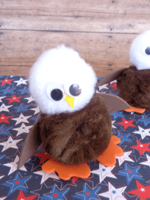 Bald eagle craft made with pom-poms.