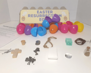 Plastic Easter eggs on table along with objects used for Easter resurrection eggs.