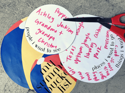 Summer bucket list written on paper in bubbles and cut out into circles.